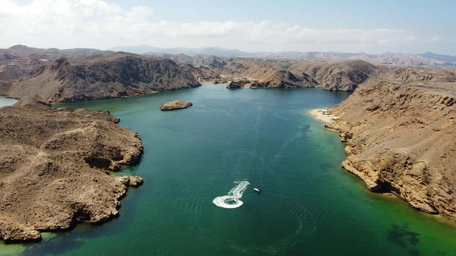 Bandar Al Khayran Jorney: Group Tour with Snorkeling - Looking for dolphins on the ride