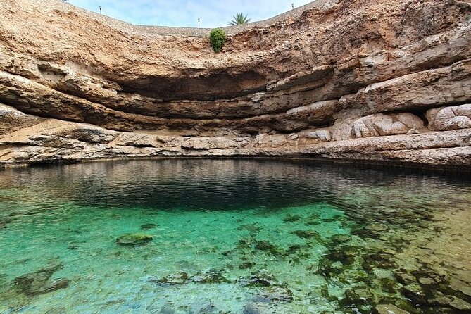 Full Day Group Tour to Wadi Shab Bimmah Sinkhole and Fins Beach - Transport, group size, and the price of $110