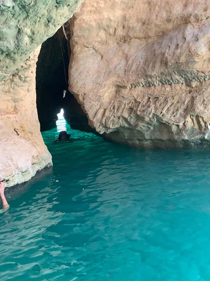 Muscat: Full-Day Wadi Shab & Bimmah Sinkhole Private Tour - Swimming toward the cave and waterfall
