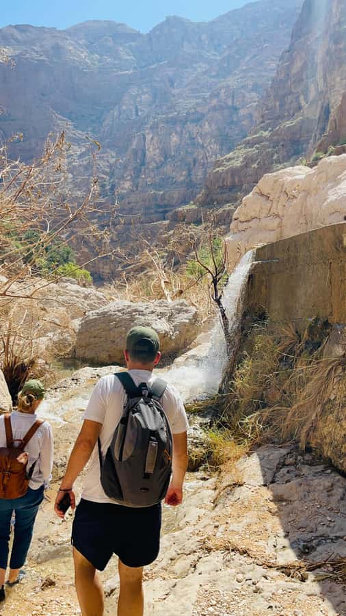 Muscat: Wadi Shab, Romantic Cave and Sinkhole Full-day Trip - Walking into Wadi Shab