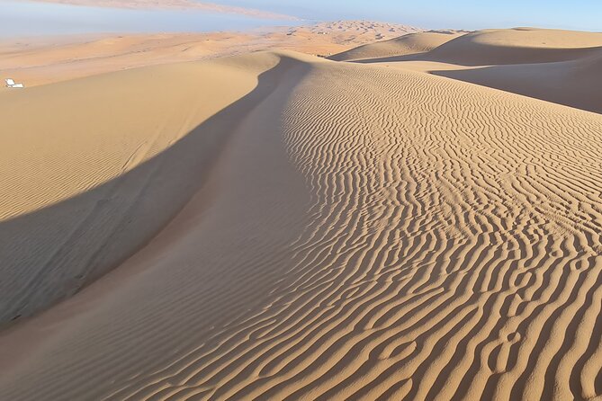 Oman Highlights: Wahiba Sands Desert & Wadi Bani Khalid Tour - Timing, heat, and the long return to Muscat