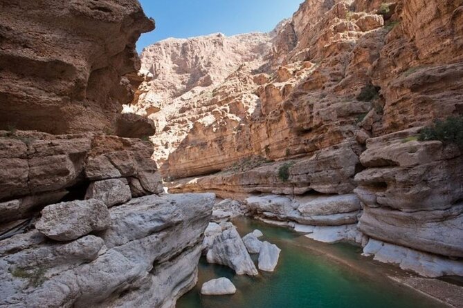 Private Full-Day Wadi Shab and Bimmah Sinkhole Tour - The boat crossing into Wadi Shab