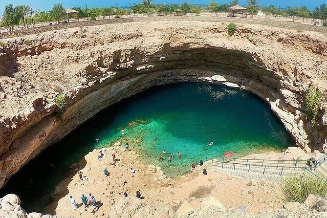 Private Full-Day Wadi Shab and Bimmah Sinkhole Tour - Swimming through pools and the narrow cave