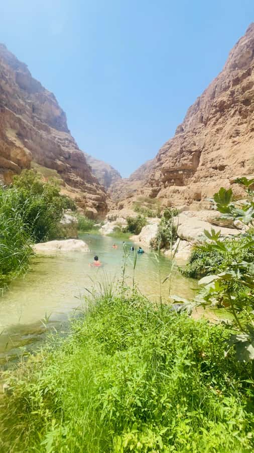 Wadi Shab Parking Meet the Local Guide for Self drivers - Swimming into the cave waterfall
